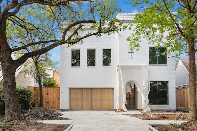 2244 N Blvd, Houston, TX 77098 - contemporary house with brick siding, fence, concrete driveway, and a garage