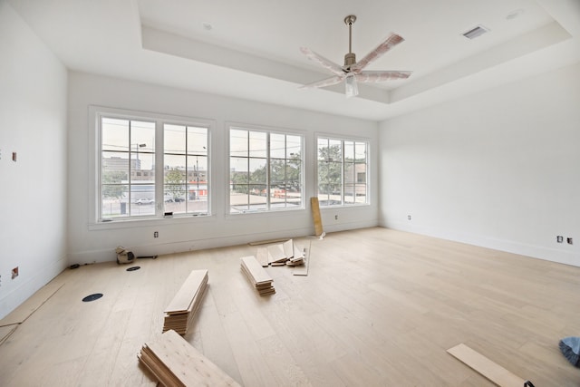 2244 N Blvd, Houston, TX 77098 - spare room with a tray ceiling, wood finished floors, visible vents, and a ceiling fan