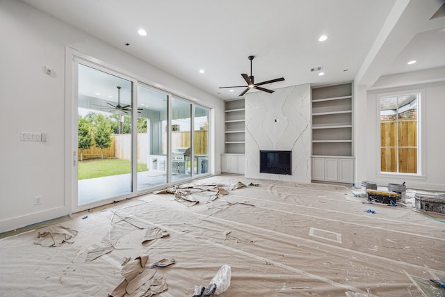 2244 N Blvd, Houston, TX 77098 - unfurnished living room featuring a ceiling fan, built in shelves, recessed lighting, a high end fireplace, and baseboards