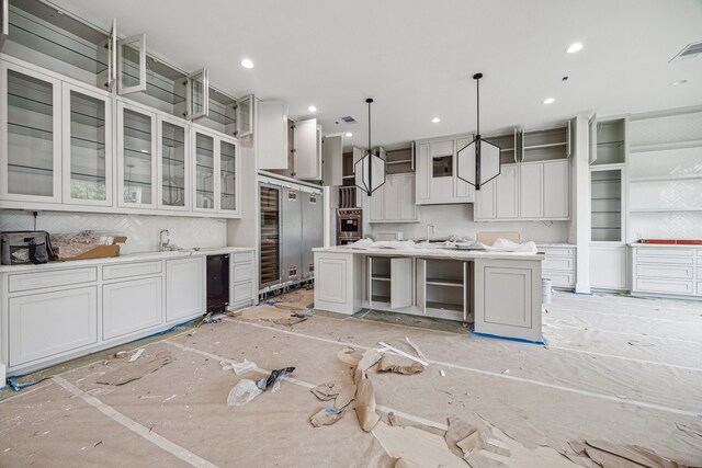2244 N Blvd, Houston, TX 77098 - kitchen featuring stainless steel oven, tasteful backsplash, a center island with sink, light countertops, and recessed lighting