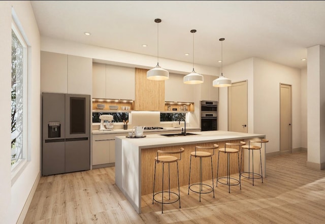 5505 Hershe St, Houston, TX 77020 - kitchen with high end fridge, stainless steel double oven, light wood-type flooring, modern cabinets, and light countertops