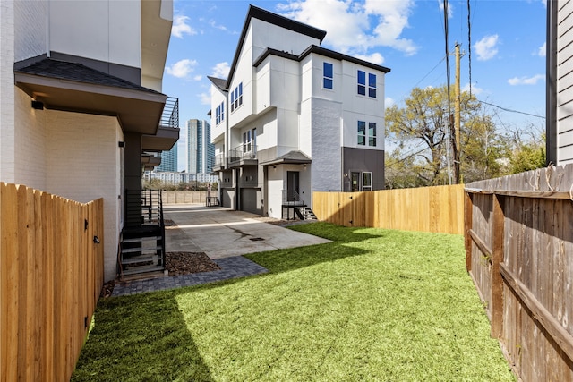 view of yard with a fenced backyard and a patio area