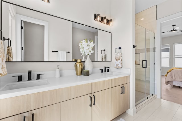 ensuite bathroom with double vanity, a stall shower, ensuite bathroom, and a sink