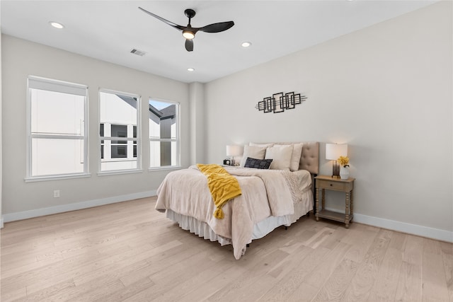 bedroom with visible vents, multiple windows, baseboards, and light wood-style floors