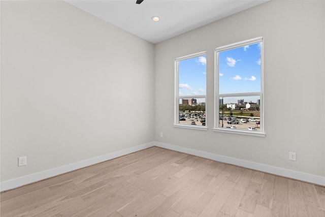 unfurnished room featuring recessed lighting, baseboards, light wood-style flooring, and a ceiling fan