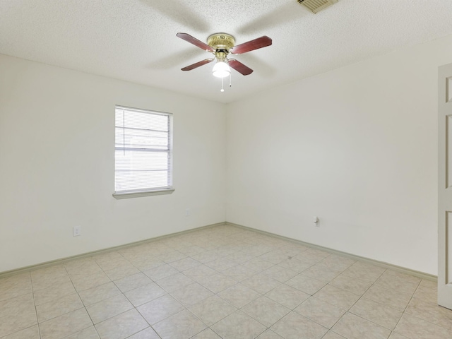 unfurnished room with a textured ceiling, visible vents, and ceiling fan