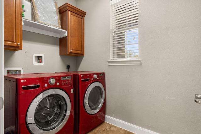 clothes washing area featuring tile patterned floors, separate washer and dryer, baseboards, and cabinet space