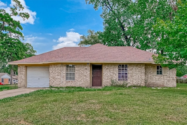 single story home featuring a front yard, an attached garage, concrete driveway, and a shingled roof