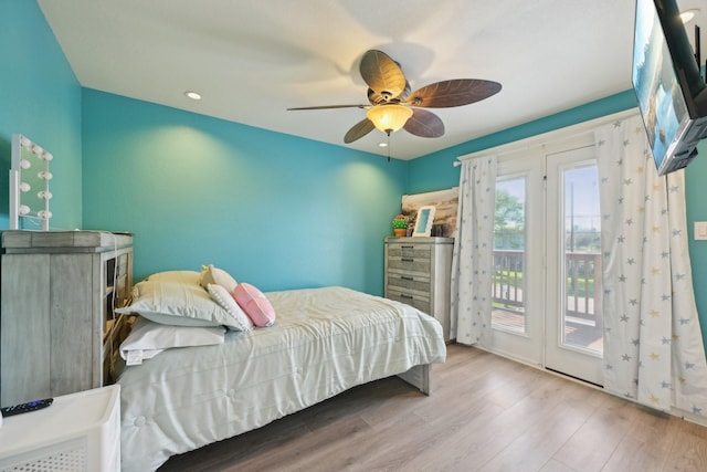 bedroom featuring access to exterior, ceiling fan, and wood finished floors