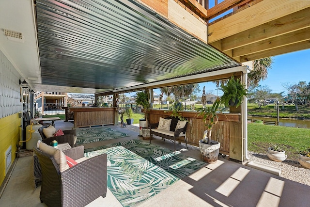 view of patio with visible vents, an outdoor hangout area, and a water view