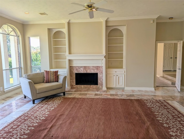 unfurnished living room featuring crown molding, built in shelves, baseboards, and a high end fireplace