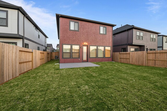 back of property with a yard, a patio, a fenced backyard, and stucco siding
