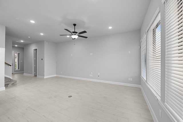 unfurnished living room with recessed lighting, stairway, a healthy amount of sunlight, and ceiling fan