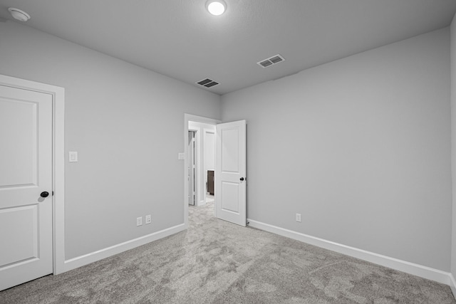 unfurnished bedroom featuring visible vents, carpet floors, and baseboards