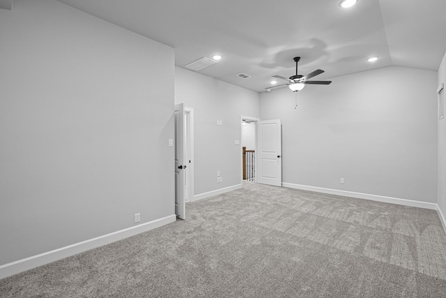 carpeted empty room with visible vents, baseboards, lofted ceiling, and a ceiling fan