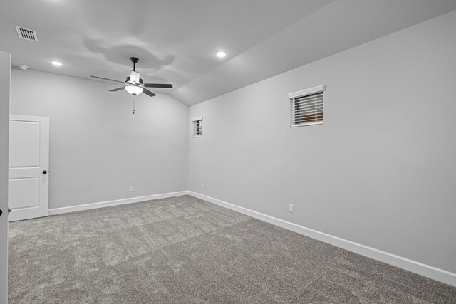 carpeted empty room featuring visible vents, baseboards, and ceiling fan