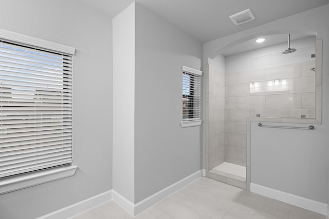 full bath with visible vents, baseboards, and walk in shower