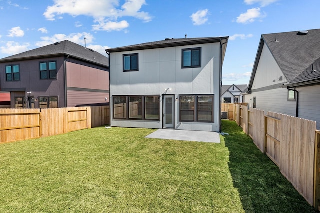 rear view of house featuring a fenced backyard, a patio area, and a yard