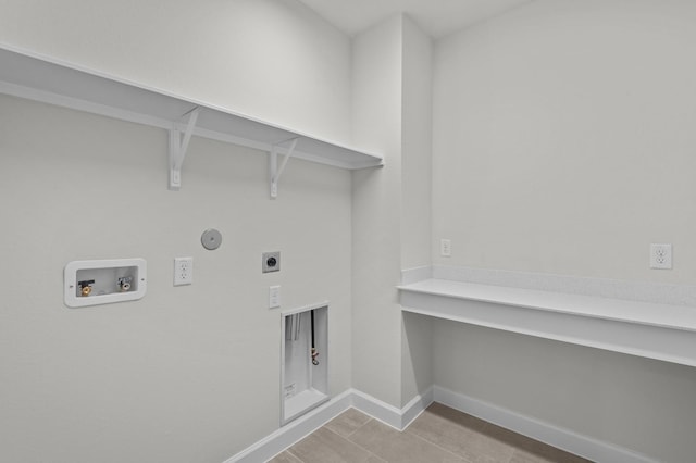 laundry area featuring baseboards, laundry area, electric dryer hookup, washer hookup, and hookup for a gas dryer