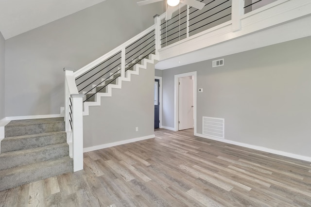 71 Deer Run Cir, Coldspring, TX 77331 - stairs with ceiling fan, wood finished floors, baseboards, and a towering ceiling