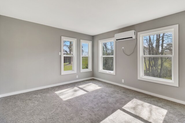 71 Deer Run Cir, Coldspring, TX 77331 - carpeted empty room featuring an AC wall unit, plenty of natural light, and baseboards