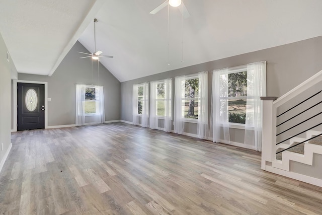 71 Deer Run Cir, Coldspring, TX 77331 - unfurnished living room with ceiling fan, plenty of natural light, high vaulted ceiling, wood finished floors, and baseboards