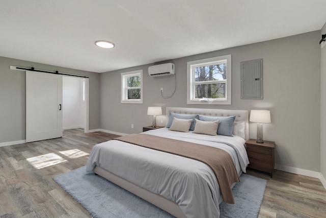 71 Deer Run Cir, Coldspring, TX 77331 - bedroom with a barn door, electric panel, an AC wall unit, and baseboards