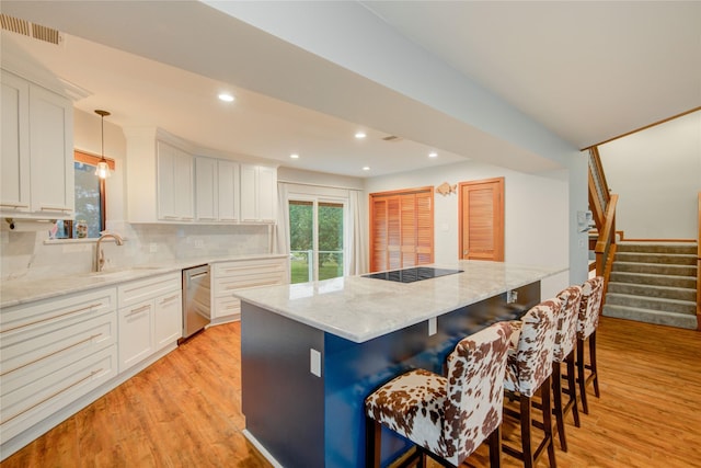 456 S Burnett Dr, Baytown, TX 77520 - kitchen with white cabinetry, a sink, light wood finished floors, and dishwasher
