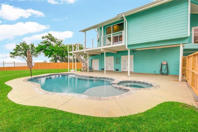 456 S Burnett Dr, Baytown, TX 77520 - view of swimming pool with stairway, a patio, a fenced backyard, a pool with connected hot tub, and a yard