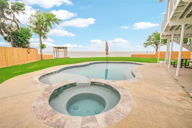 456 S Burnett Dr, Baytown, TX 77520 - view of swimming pool featuring a fenced backyard, a pool with connected hot tub, a yard, and a patio