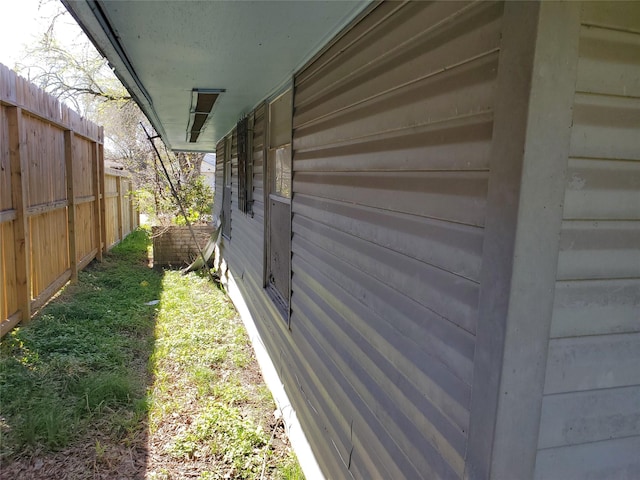view of side of home with fence