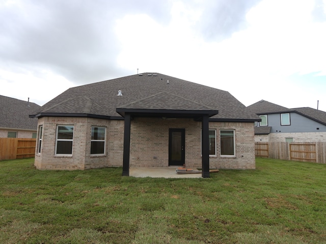 8634 Sun Coral Dr, Cypress, TX 77433 - rear view of property featuring roof with shingles, a fenced backyard, and brick siding