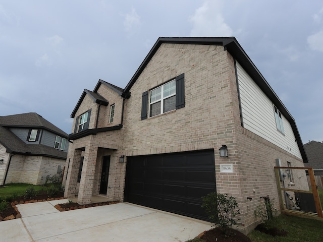 8634 Sun Coral Dr, Cypress, TX 77433 - view of front of house with brick siding, a garage, and driveway