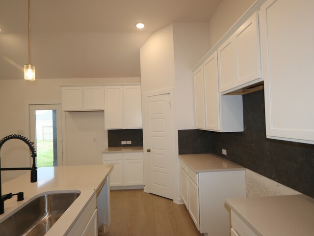 8634 Sun Coral Dr, Cypress, TX 77433 - kitchen with tasteful backsplash, white cabinetry, recessed lighting, light wood-type flooring, and dishwashing machine