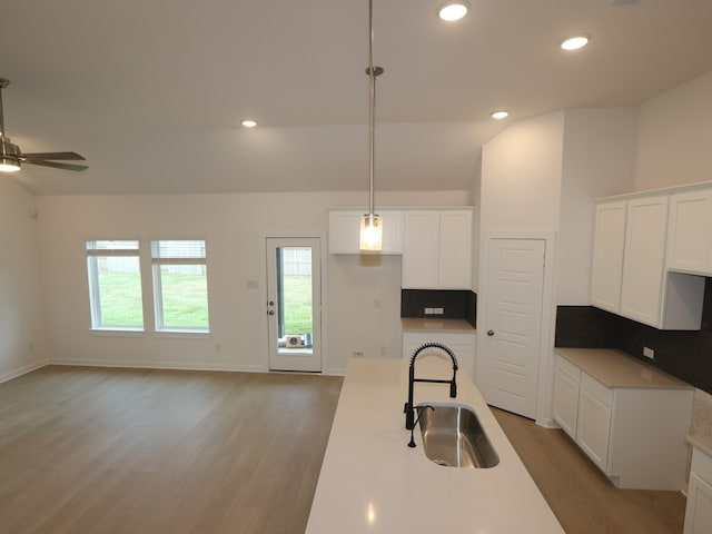 8634 Sun Coral Dr, Cypress, TX 77433 - kitchen featuring light wood-style floors, white cabinets, ceiling fan, recessed lighting, and lofted ceiling