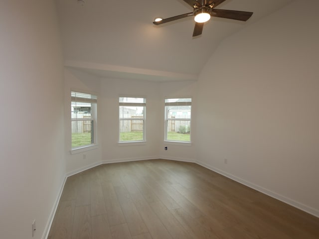8634 Sun Coral Dr, Cypress, TX 77433 - unfurnished room with wood finished floors, healthy amount of natural light, a ceiling fan, and lofted ceiling