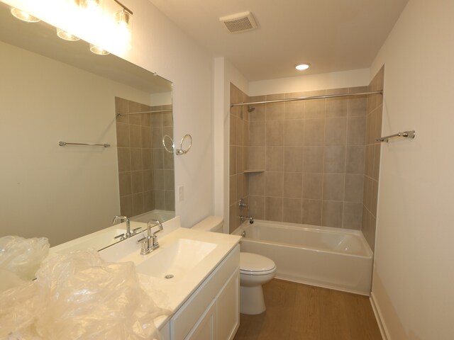 8634 Sun Coral Dr, Cypress, TX 77433 - full bathroom featuring wood finished floors, vanity, washtub / shower combination, and recessed lighting