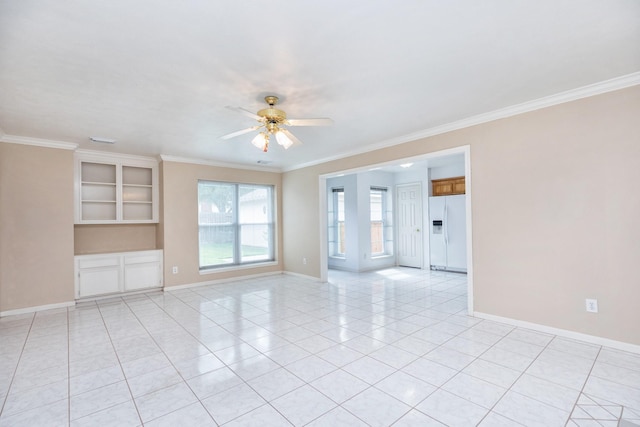 empty room with light tile patterned flooring, baseboards, a ceiling fan, and ornamental molding