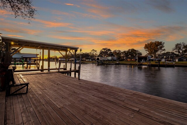 dock area with boat lift and a water view