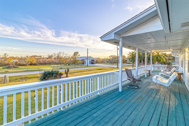 deck featuring a porch and a yard