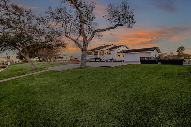 view of yard with driveway and an attached garage
