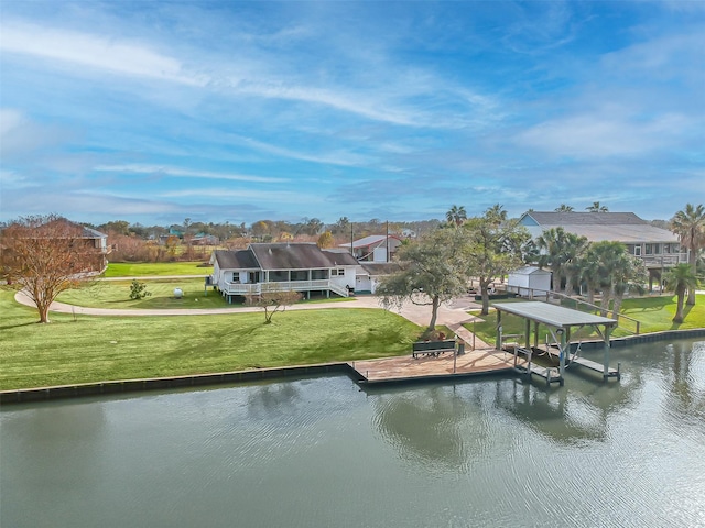 view of dock with boat lift, a lawn, and a water view