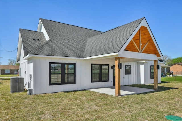 back of house with cooling unit, a patio, roof with shingles, and board and batten siding