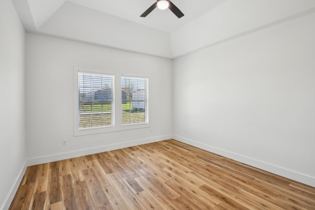 unfurnished room with baseboards, a ceiling fan, and light wood finished floors