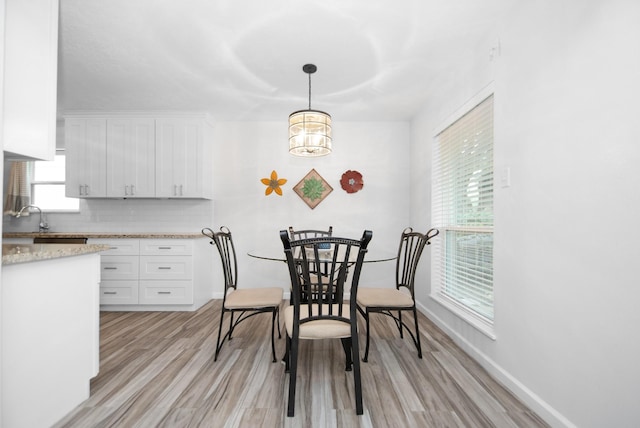 89 Bayou Ln, Kemah, TX 77565 - dining space with light wood-type flooring and baseboards