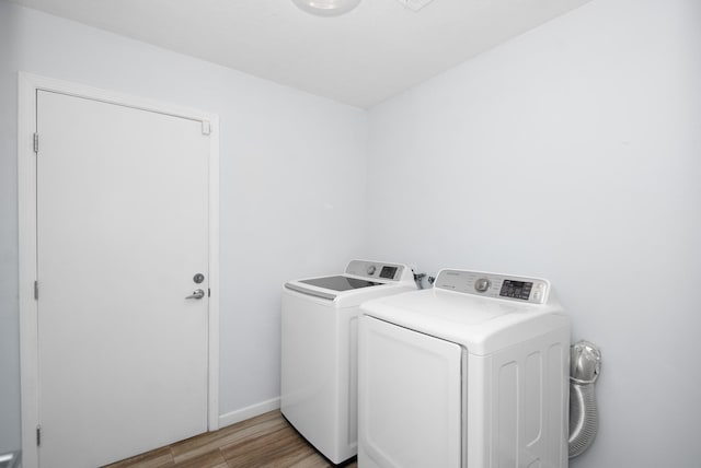 89 Bayou Ln, Kemah, TX 77565 - laundry area featuring washing machine and dryer and light wood-style flooring