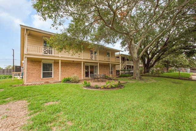 89 Bayou Ln, Kemah, TX 77565 - rear view of house with a patio, a balcony, and brick siding