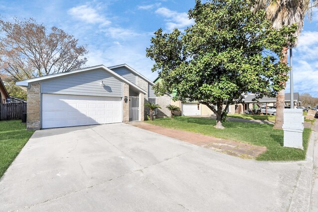 547 Walston Ln, Houston, TX 77060 - view of front of property with driveway, a front lawn, brick siding, and a garage