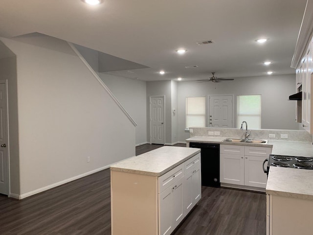 kitchen with a center island, light countertops, black dishwasher, a ceiling fan, and a sink