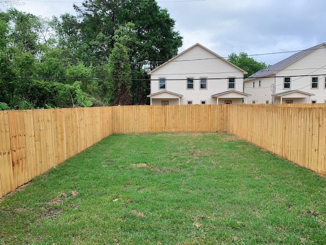 view of yard with a fenced backyard